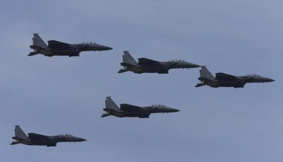 South Korean Air Force F-15K fighter jets fly in sky during celebrations to mark 65th anniversary of Korea Armed Forces Day, in Seongnam